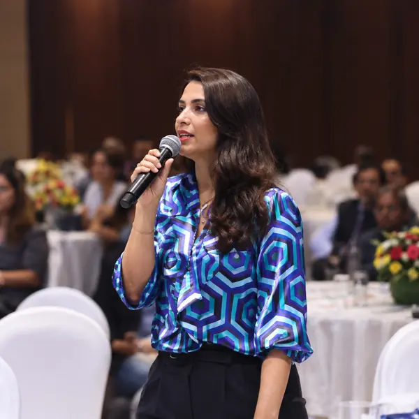 Speaker with a handheld microphone during a Q&A