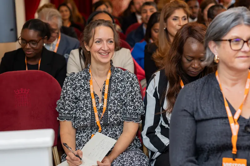 Attendees listening in the audience