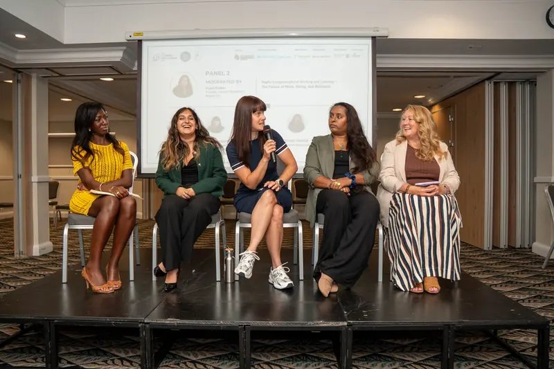 Four women speaking on a panel