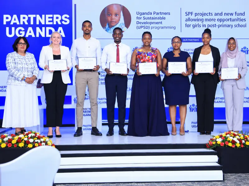 Award recipients on stage at Partners Uganda